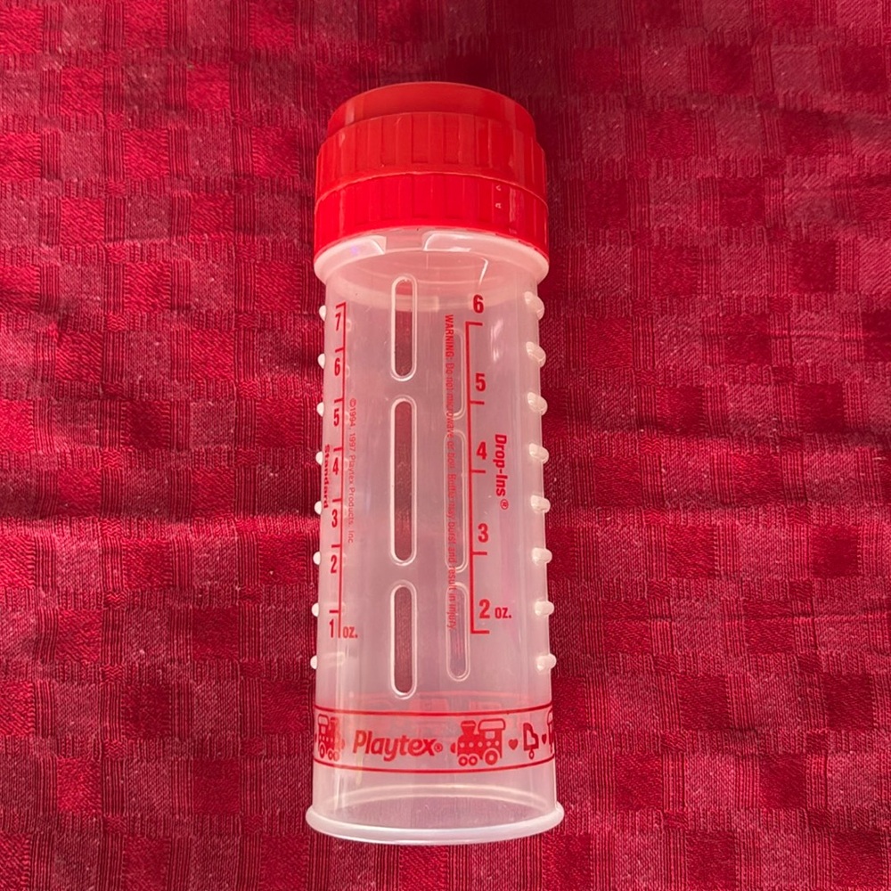 Red Playtex drop-in baby bottle